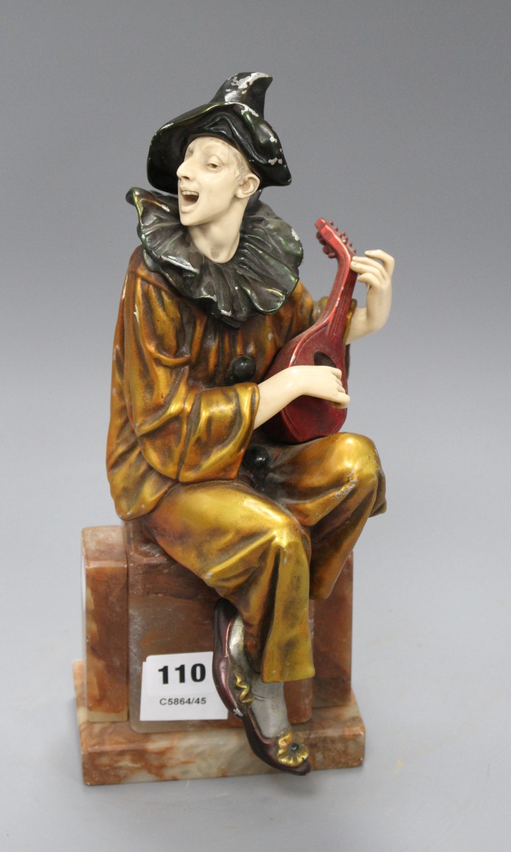 An Art Deco style soft metal and resin figure of a pierrot playing a mandolin, height 29cm